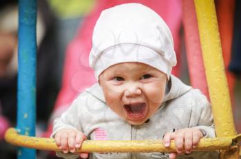 Nice little baby girl laughs on the swing