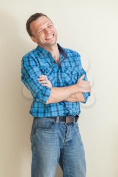 Young laughing Caucasian man in casual shirt, studio portrait 