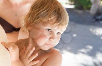 Outdoor summer closeup portrait of blond Caucasian baby girl on a vacation
