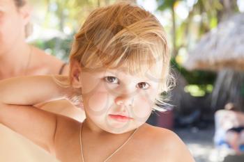 Outdoor summer closeup portrait of cute blond Caucasian baby girl