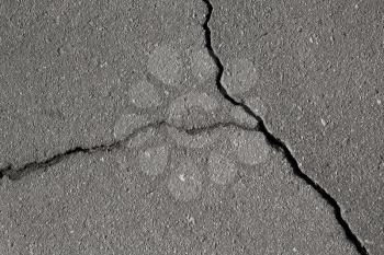 Closeup texture of damaged asphalt road surface with cracks