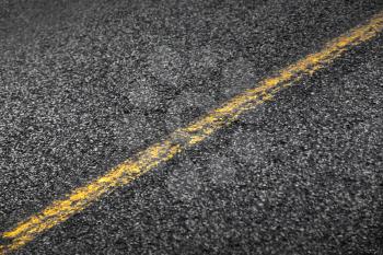 Asphalt road with yellow solid line. Transportation background texture