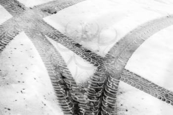 Transportation background with tire tracks on wet snow