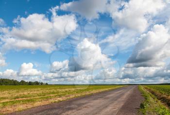 Empty asphalt country road perspective with dramatic cloudy sky