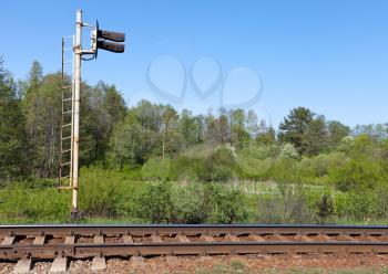 Railway fragment with semaphore and forest on a background