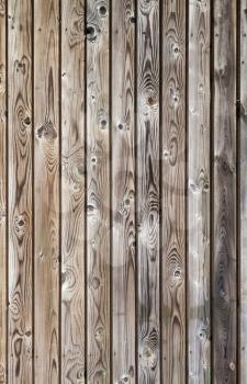 Vertical uncolored weathered gray wooden lining boards