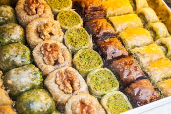Assorted baklava, it is sweet pastry made of layers of filo with chopped nuts and sweetened and held together with honey. Traditional for former Ottoman Empire and Middle East, selective focus