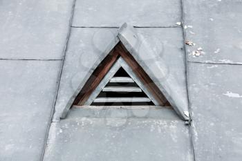 Triangle ventilation window in metal roof. Closeup photo