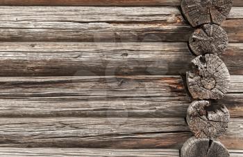 Background texture of an old rural house wall made of rough logs. Traditional rural Russian architecture detail