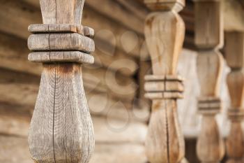Wooden balusters of terrace railings. Traditional rural Russian architecture details. Closeup photo with selective focus