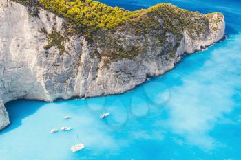 Yachts and pleasure boats moored in Navagio Bay. The most famous natural landmark of Zakynthos, Greek island in the Ionian Sea