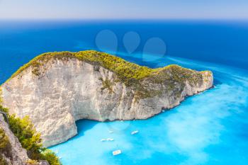 Navagio Bay with moored yachts and pleasure boats. The most famous natural landmark of Zakynthos, Greek island in the Ionian Sea