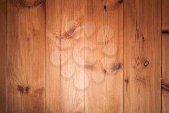 Background texture of wooden wall made of pine tree planks with central spot light illumination