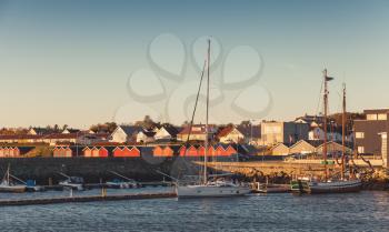 Yachts and motor boats moored in port of Brekstad, Norway. Vintage stylized photo with warm tonal correction photo filter, retro style effect