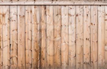 Uncolored wooden fence fragment, flat background photo texture
