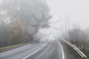Rural foggy road background photo, highway perspective in autumn season