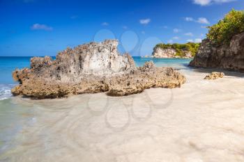 Coastal rocks and sand of Macao Beach, touristic resort of Dominican Republic, Hispaniola Island