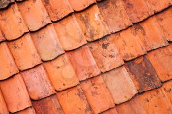 Vintage red roof tiling, close-up background photo texture, diagonal composition
