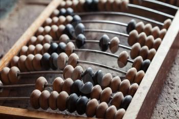 Vintage abacus lay on stone table, close up photo with selective focus