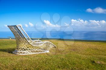 Empty wicker chair stands on the top of Montana Redonda. Dominican Republic, natural landscape photo
