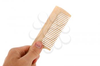 Wooden comb in the hand