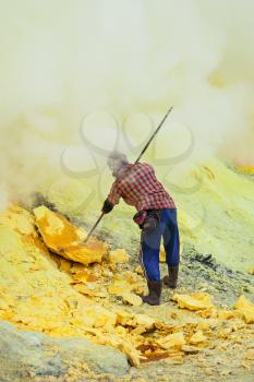 Sulfur miner inside crater of Ijen volcano, East Java, Indonesia