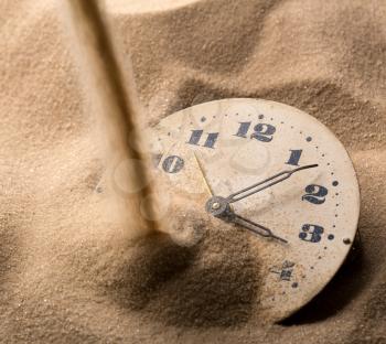 Sand pouring on old clock face