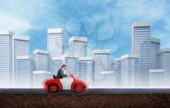 Young businessman driving a toy car agaist the city