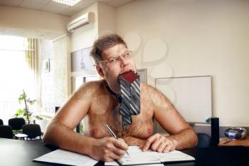 Freak naked businessman works in office