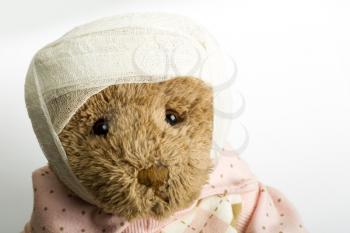 Portrait of teddy bear with bandage on the head