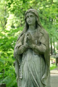 Praying statue on old cemetery