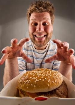 Portrait of happy man preparing to eat burger