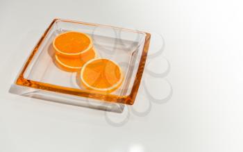 Tree pieces of an orange on a glass plate