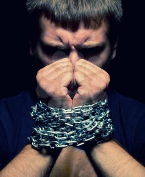 Angry man with chained hands