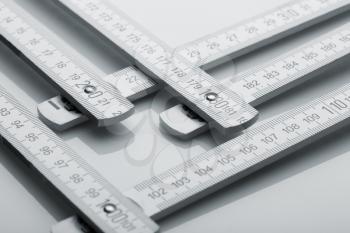 Metal metre measure ruler over white