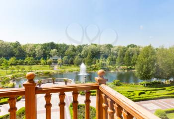 View of beautiful green park with lake from the balcony