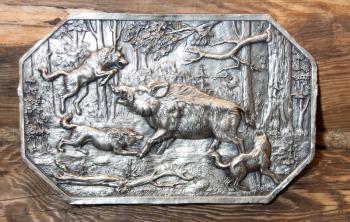 Silver engraving on the wall. Hunt scene in forest