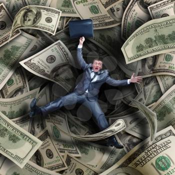 Businessman falling into tunnel of $100 dollar bills