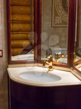 Luxurious sink with mirror in wooden house close up