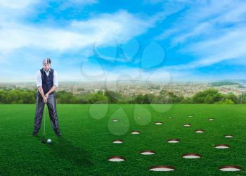 Adult businessman plays golf with many holes 