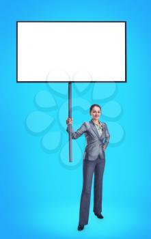 Businesswoman with white advertising banner isolated on blue