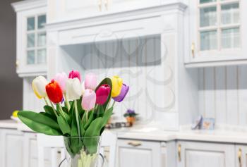 Luxury kitchen made from light wood with kitchen tulips