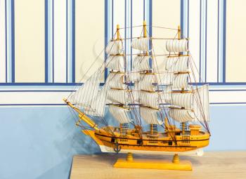 Close up shot of sail ship model on the white and blue background
