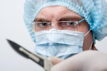 Portrait of serious surgeon with surgical knife