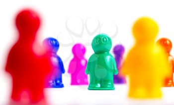 Crowd of colorful toy people on white
