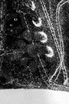 Close-up of gym shoe under water. In B/W