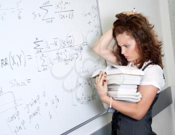 Thinking student at blackboard. Crazy mathematics