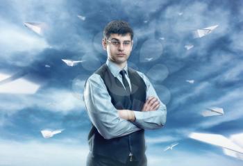 Businessman with flying paper planes  isolated on sky background