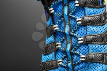 Closeup of  blue shoelaces on grey background