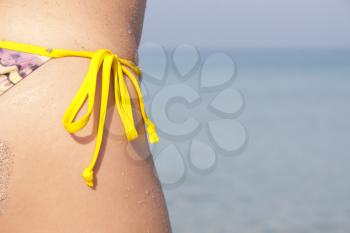 Close-up of tan wet woman in bikini